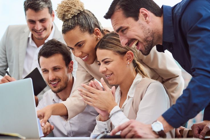 Founder working on a laptop with printed financial notes