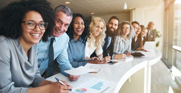 Facilitator answering questions from a group of business leaders